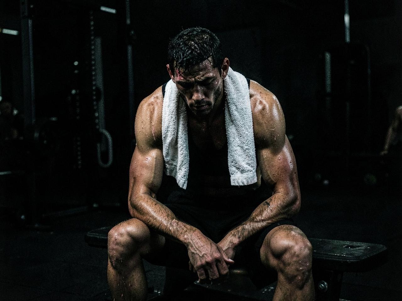 Athlete resting on a bench after training